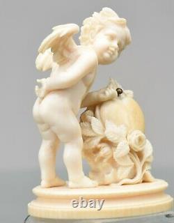 Antique Carved Figurine of Cupid with heart and arrows. Let this be your Angel