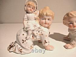 Antique Gebruder Heubach porcelain crawling piano babies pair w riders Germany